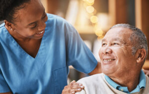 Help, support and medical with nurse and old man for retirement, rehabilitation or healing. Empathy, physical therapy and healthcare with patient and black woman in nursing home for caregiver service