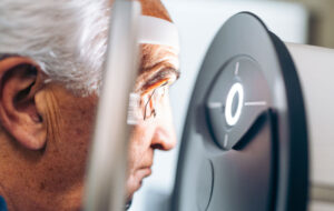 Elderly patient receives a glaucoma screening using a laser eye scanner.