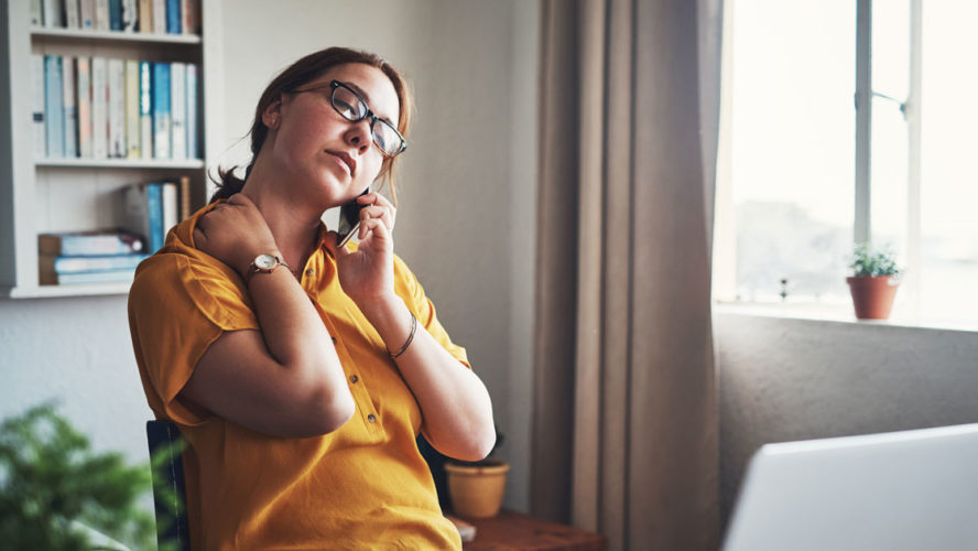 Cropped shot of an attractive young businesswoman sitting alone in her home office and feeling stressed while using her cellphone