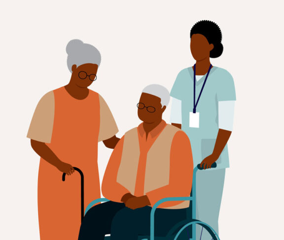 Black Senior Wife With Her Senior Husband In Wheelchair Is Being Taken Care By A Female Nurse