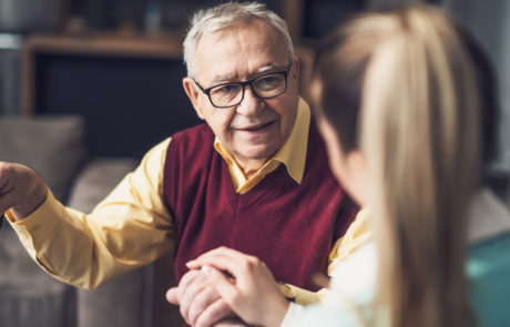 Home doctor is visiting senior man to check his health. Professional caregiver is assisting old man at his home.