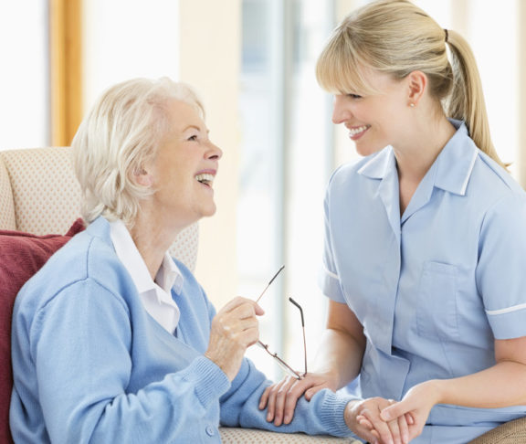 Caregiver talking with older woman