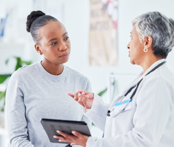 Doctor, woman and tablet for hospital, healthcare advice and support for results, exam and test on bed. Senior expert or medical people on digital tech for clinic sign up, registration and consulting