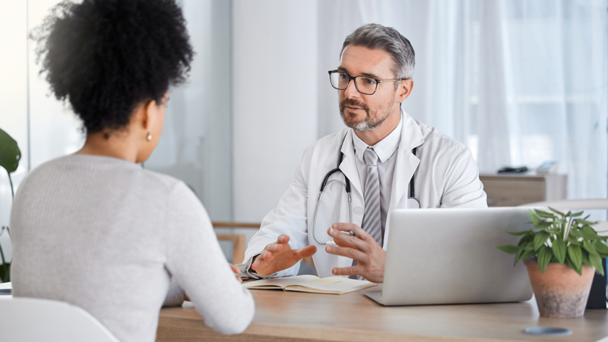 Healthcare, consultation and doctor talking to woman in after checkup