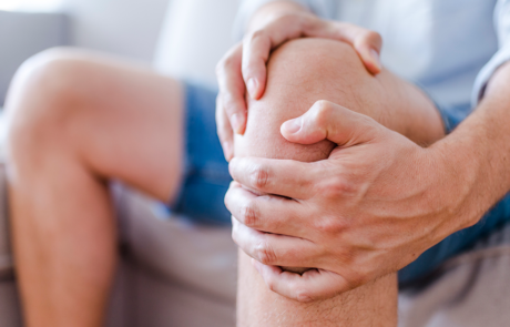 man massaging his painful knee