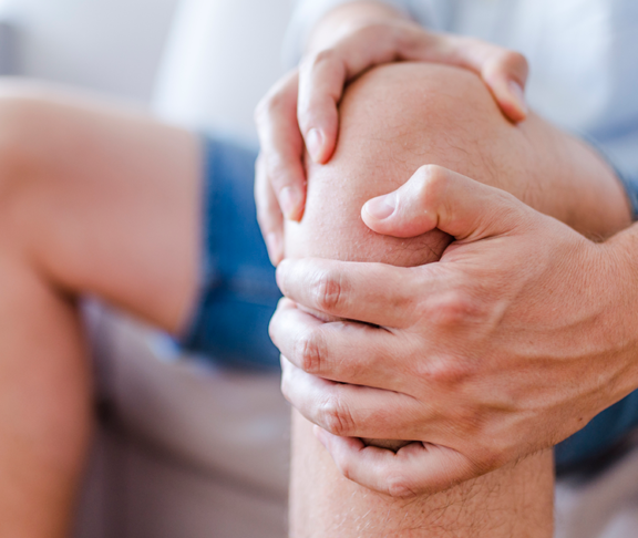 man massaging his painful knee