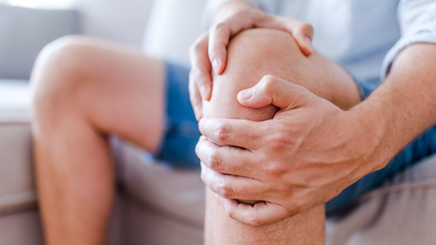 man massaging his painful knee